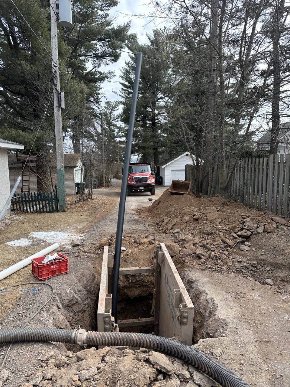 Trenchless pipe bursting equipment and HDPE pipe staged at a Duluth MN job site