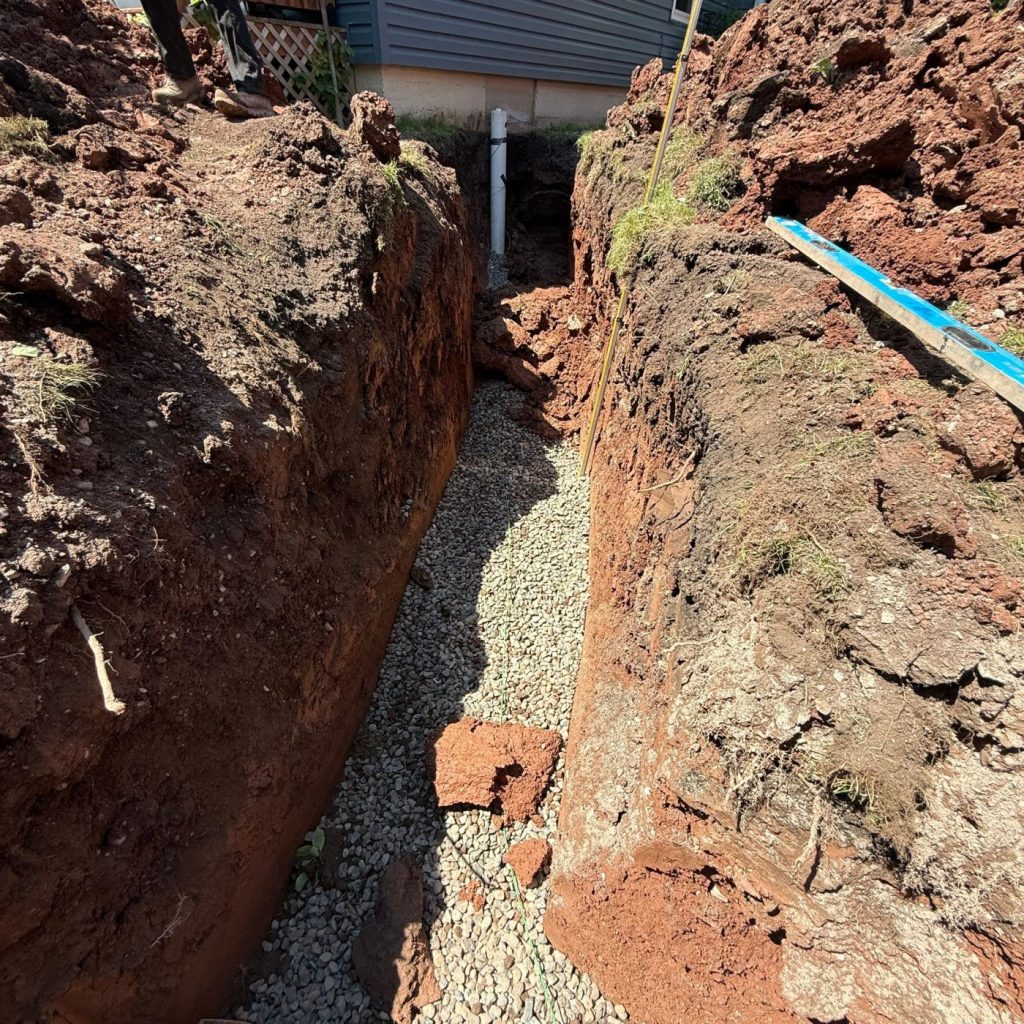 Open sewer trench with granular bedding at a Superior, Wisconsin home