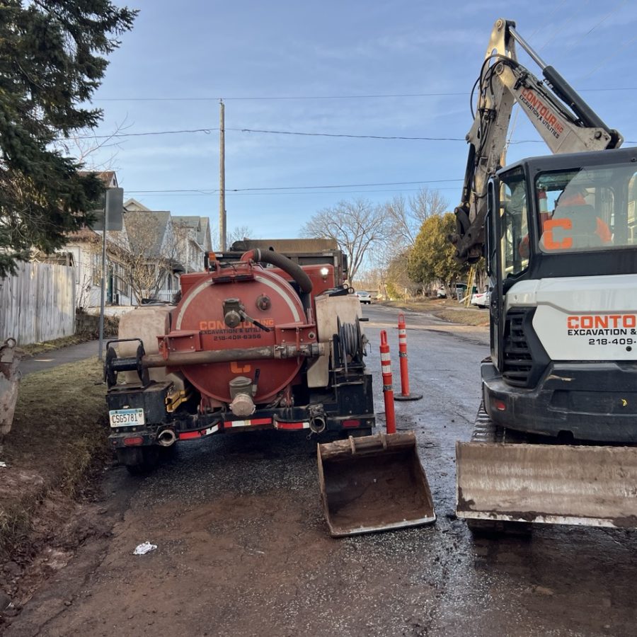 Contour Inc. excavator and hydrovac working a job site in Duluth MN